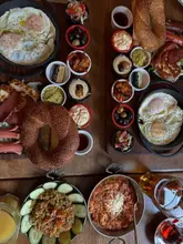 Delicious Turkish breakfast spread at Cafe Turquoise in Aberdeen, featuring halloumi, chicken sausage, eggs, and fresh bread.