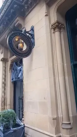 Couple enjoying Halloween-themed afternoon tea at Grand Pacific, Manchester, featuring savory dishes and delightful desserts.