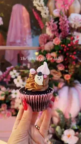 'Family enjoying cupcakes and brunch at Peggy Porschen, a charming café in Belgravia, London.'