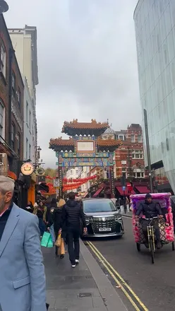 Two friends enjoying sweet and savory pastries at Master Bun Pastry in Leicester Square, featuring choc crème puffs and matcha buns.