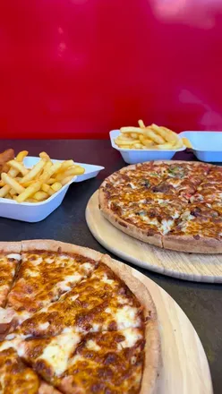 Family feast at Big Fellas: margherita pizza, Turkish delight, chicken tandoori, and a kinder bueno milkshake.