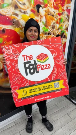 Customer enjoying a massive 24-inch pizza with diverse toppings at The Fat Pizza in Leicester.