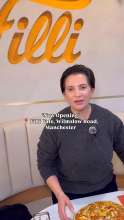 Enjoying Indian street food and desserts at FiLLi Cafe's soft launch on Wilmslow Road, Manchester, with great vibes.