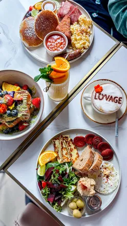 Brunch dishes at Lovage Bistro in Crouch End, featuring pancakes, Turkish breakfast, and French toast with pistachio.