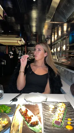 Guests enjoying unlimited sushi at Aqua Kyoto, a top London restaurant, with vibrant dishes and a cozy ambiance.