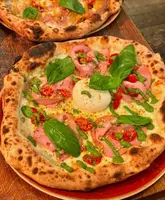 Delicious wood-fired pizzas and appetizers at The Oven Pizzeria in Bath, perfect for pre-theatre dining.