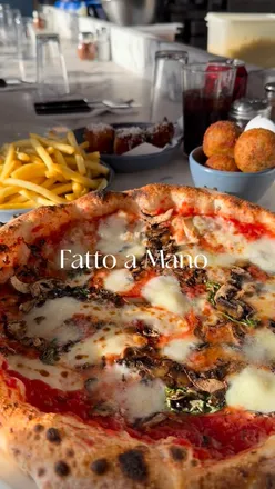 Delicious margherita buffalo pizza topped with mushrooms at Fatto a Mano in Hove, showcasing authentic Neapolitan style.