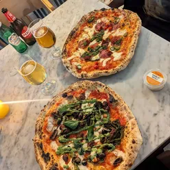 Delicious customizable pizza with long stem broccoli at Rudy's, a top choice for pizza lovers in the South East.