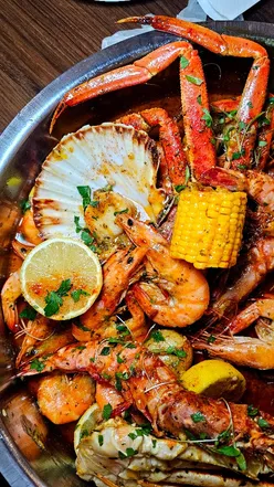 Deluxe seafood boil featuring lobster, crab, prawns, scallops, and more at Rock & Scallop, Swansea's top seafood spot.