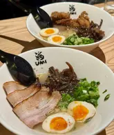 Sister enjoying signature paitan ramen at Umi, Shandwick Place, Edinburgh on a chilly day.