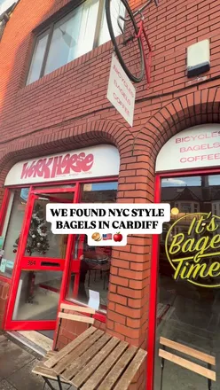 Bagels and coffee at Workhorse Bikes Cafe in Cardiff, featuring smoked salmon and bacon bagel options.