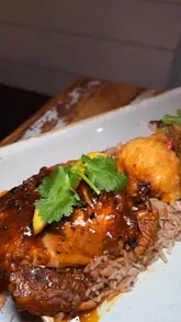 A short, punchy food showcase video featuring various Caribbean dishes like Jerk Chicken, Curry Goat, and Grilled Lamb Chops. The video focuses entirely on the food presentation with close-up shots, using music to drive the pacing.