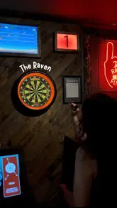 A montage video showcasing a visit to The Raven in Glasgow, featuring shots of the bar, cocktails, pub food like burgers and deep dish pizza, and friends playing darts.