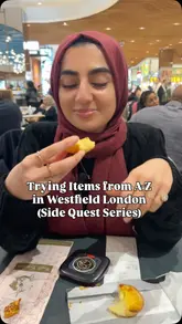 A creator attempts an A-Z food challenge at Westfield White City, visiting various cafes and eateries to try different items. The video features the creator's reactions and reviews of each item, including chocolates, puddings, pastries, frozen yogurt, bubble tea, and Korean street food.