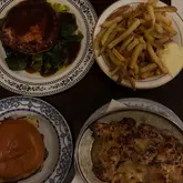 Cozy pub atmosphere at The Jolly Gardeners in Chester, featuring flavorful pâté, hummus, burger, and turkey bacon pie.