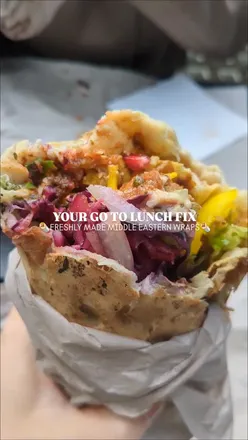 Chargrilled chicken and lamb kofte wrap from Zawa, a Middle Eastern eatery in Hayes, Cardiff, served with fresh salad.