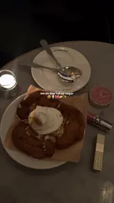 A short, aesthetic video montage featuring close-up shots of food items like cookies with ice cream, fish sliders, and a Caesar salad, interspersed with shots of the restaurant's interior and exterior. The video uses a slow, relaxed pace with music and minimal text overlays to highlight the dining experience at Le Cafe Nac in Belgravia.