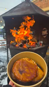 A creator visits 'Propa' at Sheepfolds Stables in Sunderland to try their pie and mash. The video features shots of the food, the outdoor fire pit, and the creator enjoying the meal in the cold weather.