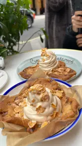 The creator visits NAC restaurant in London to review their signature cookie dough dessert topped with ice cream and frosted flakes. The video features the creator's personal reaction, shots of the food, and glimpses of the restaurant's interior and exterior.