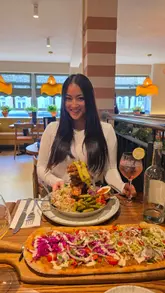 A video review of Gallio restaurant in London, featuring a variety of Mediterranean-inspired dishes including skewers, prawns, croquetas, and flatbreads. The creator showcases the interior and the dining experience with family.