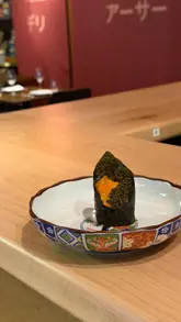 A montage of high-quality omakase sushi dishes being prepared and served at a restaurant in Chelsea, London. The video focuses on close-up shots of premium ingredients like uni, caviar, and prawns, set to music with minimal text overlays.