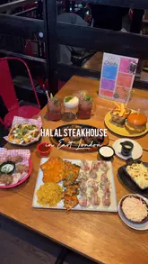 A short-form video showcasing a variety of dishes at a Halal steakhouse in East London, featuring close-ups of steaks, burgers, wings, and sides.