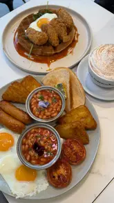 Brunch at The Crêperie Co in Denton featuring a full English, chicken waffle, and gingerbread chai latte.