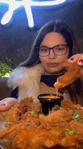 A creator visits a Turkish restaurant called Amoura, showcasing the interior, various dishes including crispy chicken, meze, lamb kofta, and a fruit platter, while providing a positive review of the food and atmosphere.