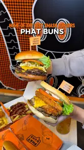 A fast-paced montage showcasing various burgers, loaded fries, and drinks from Phat Buns, featuring close-up shots of the food and glimpses of the venue's interior branding.