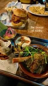 A montage video showcasing the interior, menu, drinks, and food offerings at The George at Kilsby, a pub venue.