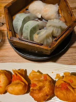 Brother and sister enjoying crispy wontons, dim sum, and iron pot noodles at Muswanna in Swansea after Winter Wonderland.