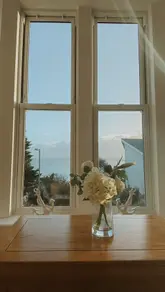A promotional video showcasing the interior of Porthminster View in St. Ives, including the living area, bedroom, and swimming pool, ending with a sunset beach shot.