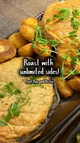 A creator visits Pivot Bar and Bistro in London to try their vegan roast deal, highlighting the unlimited sides and the quality of the food.