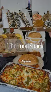 A fast-paced montage showcasing various takeaway items from The Food Shack, including a spicy chicken burger, donner stir fry, beef cheese bake, donuts, and waffle sticks. The video focuses on close-up shots of the food to highlight textures and ingredients.