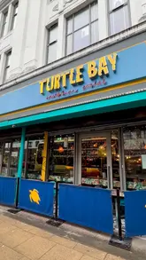 A short, handheld-style montage showcasing the interior, menu, and food offerings at a Turtle Bay restaurant, highlighting a January set menu deal.