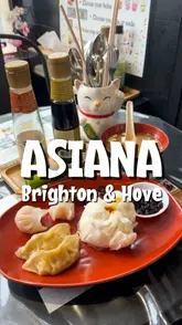 Delicious dim sum selection at Asiana Grocery in Hove, featuring gyoza, buns, and more in a cozy dining space.
