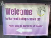 A montage of clips showing children visiting Hartwell Riding Stables for a Christmas-themed event, featuring pony rides, games, and a meeting with Santa.