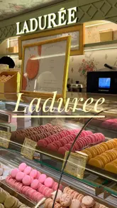A creator visits a Ladurée location to try their vegan chocolate passion fruit macaron, sharing her thoughts on the flavor and texture with her cousin.
