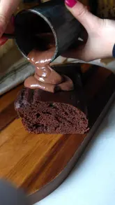 A short, fast-paced recipe video demonstrating how to make a 'period healing' chocolate cake at home. The video features close-up shots of the ingredients and the mixing process, followed by the finished product.