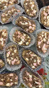 A home cooking tutorial demonstrating how to make a 'Kinder 15,' a variation of a traditional Northern Irish no-bake traybake. The video follows the creator through the process of crushing cookies, mixing ingredients, shaping the log, and chilling it.