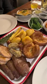 A video showcasing a Sunday roast sharing platter at The Moldy Fig, featuring close-ups of the food, gravy pouring, and shots of the restaurant's interior and decor.