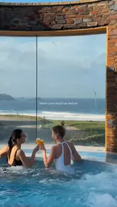 A cinematic montage showcasing a luxury hotel stay in Cornwall, featuring shots of the hotel exterior, spa facilities, bedroom, and dining experiences.
