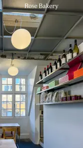 A short, atmospheric video showcasing Rose Bakery located at the top of Dover Street Market in London. The video features shots of the interior, the bakery counter, and the seating area, accompanied by music and text overlays describing the location.
