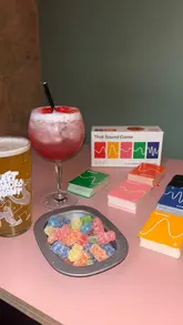 A montage video showcasing a visit to Chance & Counters, featuring shots of the venue's interior, various board games, and a selection of drinks including a boozy milkshake, a cocktail, and beer.