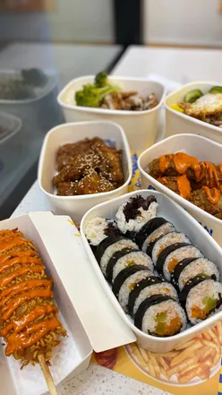 Delicious Korean food spread at Bunsik in Cabot Circus, featuring corn dog, fried chicken, rice boxes, and tuna kimbap.
