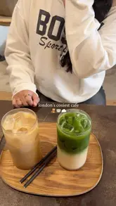 A short, aesthetic montage showcasing the interior and drinks at a London cafe called FILTRD. The video uses slow, deliberate shots to highlight the minimalist decor and the presentation of an iced coffee and a matcha latte.
