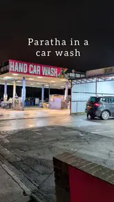 A short, fast-paced video showcasing a visit to Paratha Hut, a casual eatery located behind a car wash. The video features shots of the cooking process, the final dishes, and the interior, set to music with minimal text overlays.