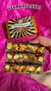 A short, handheld video showcasing various vegan chocolate bars from a Swedish brand, with a specific focus on breaking open a 'Vegickers Spell' bar to reveal the peanut, caramel, and nougat filling.