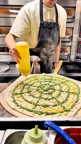 A short-form video featuring a visit to Vincenzo's Pizza in Shoreditch. The creator highlights the shop's NYC-inspired slice culture combined with Italian craft, showcasing the pizza-making process, the interior, and tasting specific slices like the spanakopita and burrata options.