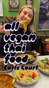 A short, engaging vlog-style reel showcasing a visit to Mali Vegan Thai in Earls Court, London. The video features close-up shots of various vegan Thai dishes, including Khao Soi and papaya salad, interspersed with clips of the creator enjoying the meal and the restaurant's atmosphere.